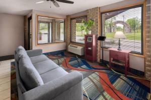 a living room with a couch and a table at Baymont by Wyndham Logan in Logan