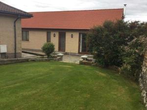 a house with a yard with a grass yard sidx sidx sidx at Langley Cottage Retreat Sleeps 2 Long Stay 20-min to Banniskirk Hub in Wick