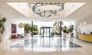 a large lobby with a chandelier in a building at Agamim by Isrotel Collection in Eilat +78 photos