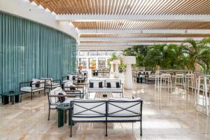 a restaurant with chairs and tables in a building at Agamim by Isrotel Collection in Eilat