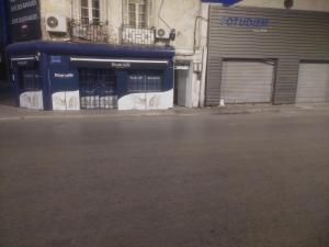 an empty street in front of a building at Emeraude in Tunis