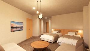 a hotel room with two beds and a table at Yutorelo Nikko in Nikko +34 photos