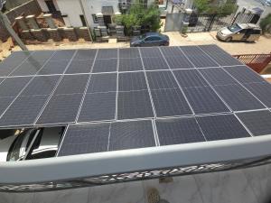 a group of solar panels on top of a roof at House 27 Cool vibes in Idu +2 photos