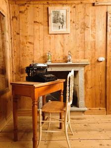 a wooden room with a wooden table and a table and chairs at Locanda Teggiate in Madesimo