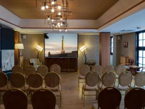 a conference room with chairs and a podium with the eiffel tower at Mercure Belgrade Excelsior in Belgrade