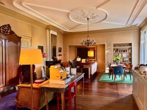 a living room with a table and a dining room at Villa Abbekerk - Bed & Breakfast in Abbekerk