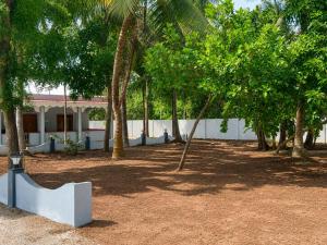 a bench in front of a building with trees at DNN Brothers Villa in Jaffna +6 photos