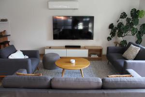 a living room with two couches and a coffee table at Sunbury on the Park in Sunbury