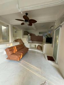 a living room with a couch and a ceiling fan at Khao Raa Terrace @Phangan in Ban Madua Wan