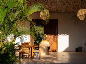 a person sitting at a table in a room at Sukacita Hill in Uluwatu