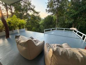 a patio with two couches and a tennis court at Khao Raa Terrace @Phangan in Ban Madua Wan +17 photos