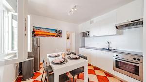 a kitchen with a white table and chairs in a room at Villa Toma by Villas Guide in Orebić