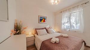 a bedroom with a bed with two towels on it at Villa Toma by Villas Guide in Orebić +33 photos