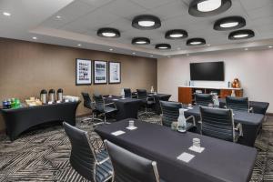 a conference room with tables and chairs and a screen at Hyatt Place New York City - Times Square in New York