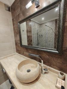 a bathroom with a sink with a large mirror at Семеен хотел"Свети Георги" in Burgas +15 photos