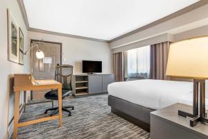 a hotel room with a bed and a desk at Country Inn & Suites by Radisson, Metairie New Orleans , LA in Metairie