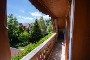 a balcony with a view of a garden at Penzion Berc in Bled