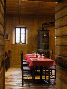 a dining room with a table and a stove at Locanda Teggiate in Madesimo