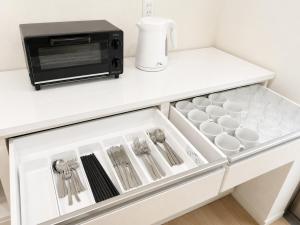 a kitchen counter with a microwave and a drawer at Nakijin Terrace in Nakijin