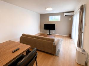a living room with a couch and a table at Nakijin Terrace in Nakijin