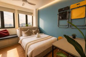 a bedroom with a bed and a tv on the wall at Riveria City by Nomadnest in Kuala Lumpur