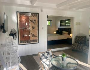 a living room with a bed and a table and a bedroom at Studio self-contained and recently renovated in Avarua