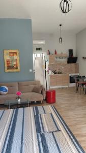 a living room with a couch and a table at Victoria's dream in Filiatra