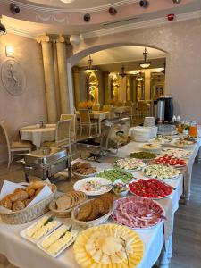 a buffet line with many different types of food at Hotel Polonia in Ostrów Wielkopolski