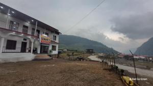 a building with a view of a mountain at Swastik Hotel & Restaurant in Kharsālī