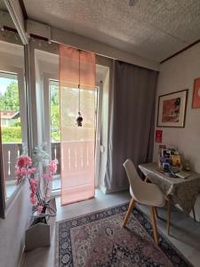 a room with a door and a chair and a table at Villa Blu in Sankt Kanzian
