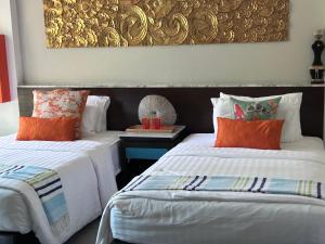 two beds sitting next to each other in a room at Karon Beach Stunning 2 bed apt unit 700 in Karon Beach +13 photos