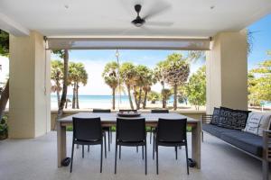 a dining room with a table and chairs and the ocean at Karon Beach Stunning 2 bed apt unit 700 in Karon Beach