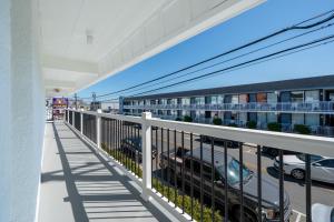 an apartment balcony with cars parked in a parking lot at Ocean's Edge Luxury Rentals in Ocean City
