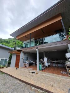 a house with a balcony and a patio at Rim Tarn Phu View Chiang Mai in Ban Khanin Tai
