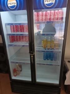 a refrigerator filled with drinks and soda at Fourways guesthouse & spa in Fourways