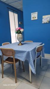 a table with a vase with flowers on it at homestay chendorini cherating in Kampong Chendar