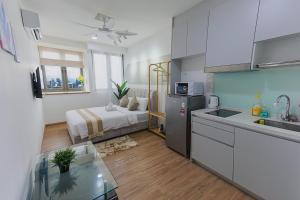 a kitchen and a bedroom with a bed in a room at Riveria City by Nomadnest in Kuala Lumpur