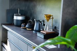 a counter top with a blender and other items on it at Villa LUAR in Minamiawaji