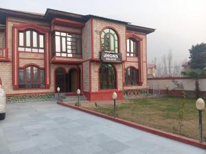 a large brick building with a mooseyes sign on it at John's palace in Srinagar +16 photos
