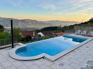 a swimming pool with a view of the mountains at Casa Letrigo in Arcos de Valdevez
