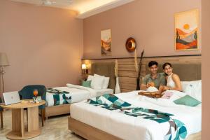 two people sitting on beds in a hotel room at Moustache Select Rishikesh Mohanchatti in Mohan Chatti +45 photos