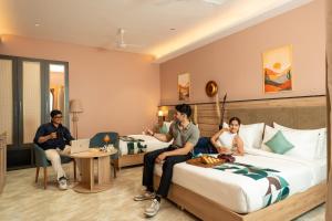 a group of people sitting in a hotel room at Moustache Select Rishikesh Mohanchatti in Mohan Chatti