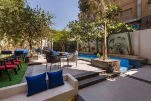 a patio with a table and chairs and a pool at Exclusive savings at 22 by spacey #43 Studio in Maadi in Cairo