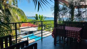 a balcony with a table and a view of the ocean at Nosy Bay View in Nosy Be