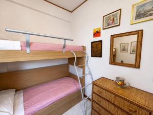a bedroom with two bunk beds and a mirror at Oasi Palma - Mondello in Palermo