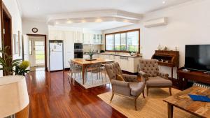 a kitchen with a table and chairs and a dining room at Sals Cottage in Busselton
