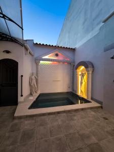 a swimming pool in the middle of a building at AniCa IV De Cine in Tomelloso