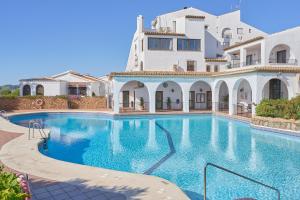 a large swimming pool in front of a building at Villa en Capistrano V. 4 a 9 plazas in Nerja