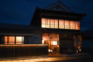 a lit up building at night at あかり by 4S STAY in Uchiko