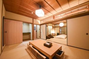 a room with a bed and a table in it at あかり by 4S STAY in Uchiko